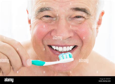 Happy Senior Man Brushing His Teeth Stock Photo Alamy