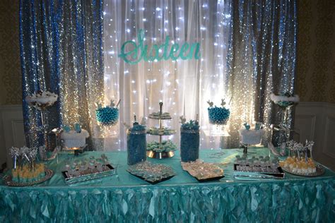 sweet 16 candy station for cinderella theme party decorated in turquoise silver and white