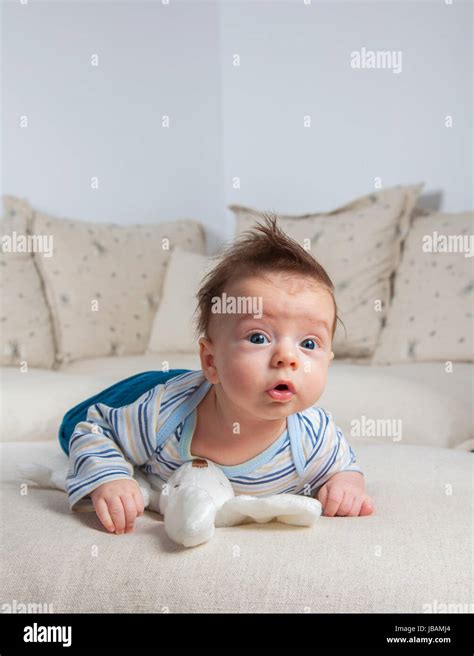 3 Months Old Baby Boy Portrait At Home Laying On Is Tummy Stock Photo