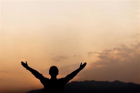 Silhouette Of A Man Lift Hands Up And Prayer At Sunset Concept Of