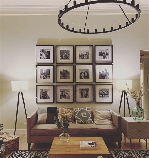 A Living Room Filled With Furniture And Framed Pictures On The Wall