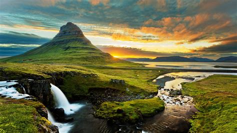 Waterfalls Pouring On River Green Grass Covered Mountains Peak Under