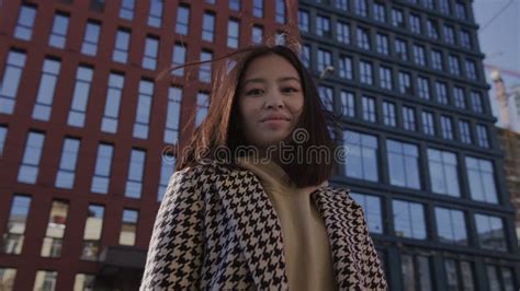 Low Angle Shot Of An Asian Woman In Downtown Camera Pivoting Around