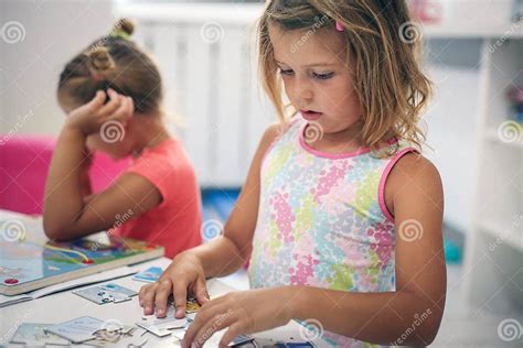 Two Little Girls Playing Together In Playground Stock Photo Image Of