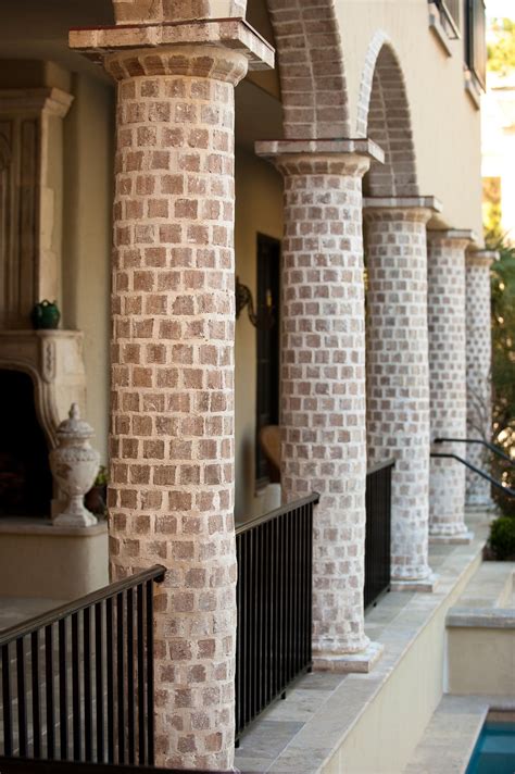 Front porch post with hanging planters. Round Brick Column Loggia with Brick Arches and Black ...