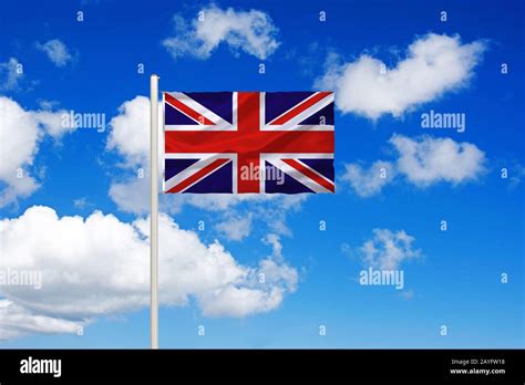 Flag Of United Kingdom In Front Of Blue Cloudy Sky United Kingdom