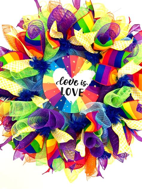 A Colorful Wreath With The Words Hope Is Love Written On It And Ribbons