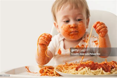 Mixed Race Baby Boy Eating Spaghetti High Res Stock Photo Getty Images