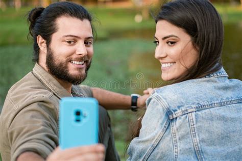 brazilian couple taking selfie with mobile in the park stock image image of cheerful happy