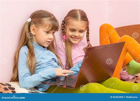 Two Girls Play Computer Games On Laptop Stock Photo Image Of Pastime