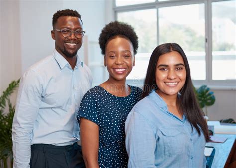 Group Of Smiling Business People Pose Arms Folded In Office Diverse