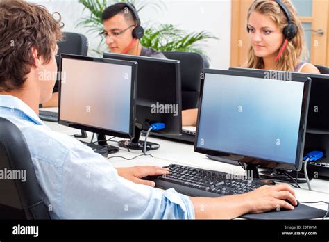 Group Of Students Working On Computers In Classroom Stock Photo Alamy