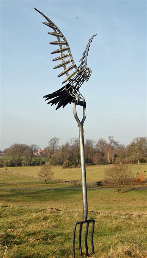 Kestrel Garden Sculpture In Forged Iron Coming In To Land On A Garden Fork