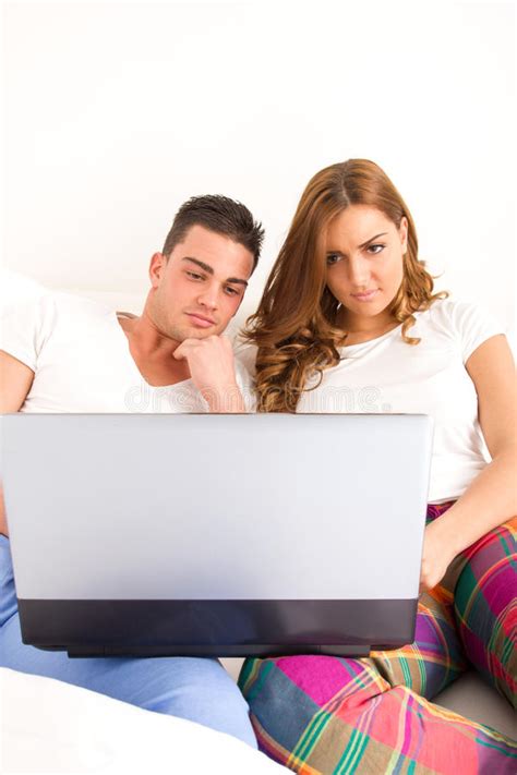 Happy Couple Enjoying Using Laptop Computer In Bed Stock Image Image