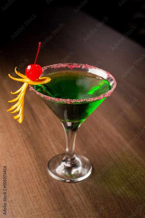 Green Drink Cocktail With Cherries In A Martini Glass Cherries And Lime Zest At The Bar Stock