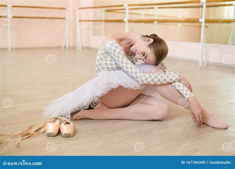 Beautiful Ballerina In Body And White Tutu Is Training In A Dance Class