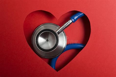 Closeup Of Blue Medical Stethoscope And Red Paper Heart Shape Concept