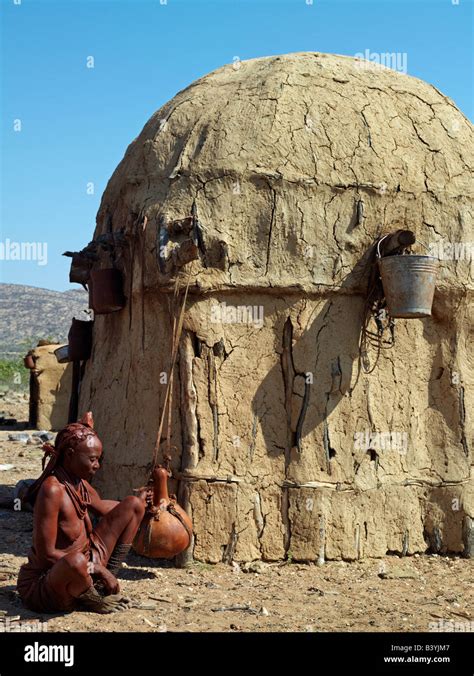 Namibia Kaokoland An Old Himba Woman Gently Shakes A Large Milk Gourd