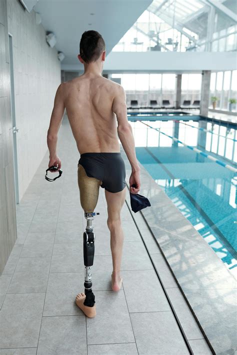Man With Prosthetic Leg Walking By Swimming Pool · Free Stock Photo