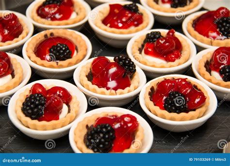 Mini Cherry Piestarts On Plates Garnished With Blackberry Stock Image