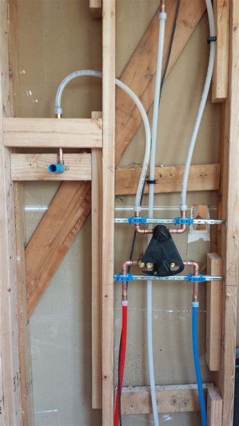 Rough plumbing a shower valve. New shower valve rough-in with PEX piping on a 3 function ...