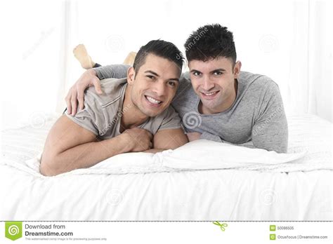 Young Attractive Gay Men Couple Lying On Bed Happy Together In Love