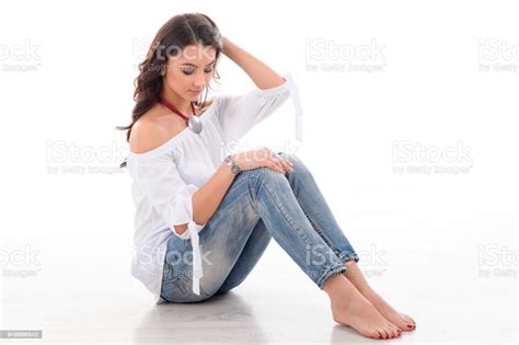 Beautiful Barefoot Girl Model Sitting On The Floor With Her Long Brown