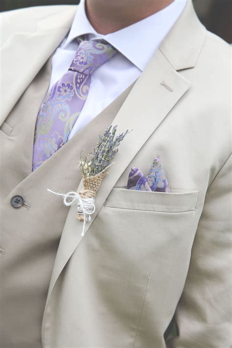 Tan Three Piece Suit With Patterned Tie And Lavender Boutonniere