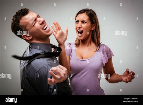 Angry Aggressive Wife Trying To Hit Her Husband Stock Photo Alamy