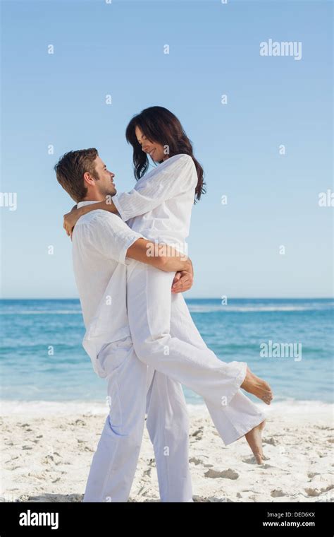 Happy Man Holding Woman In Arms Stock Photo Alamy