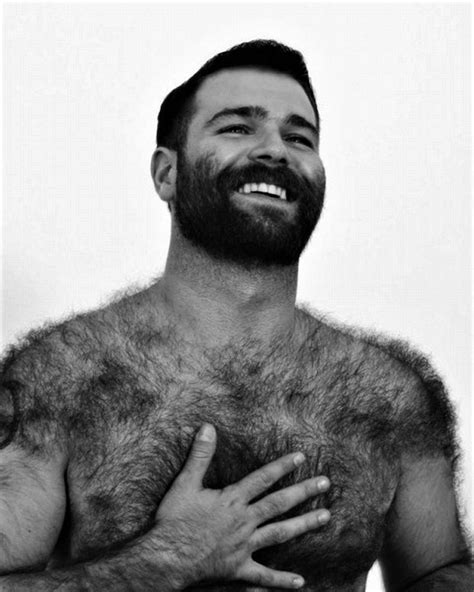 A Man With Hairy Chest And Beard Holding His Hands In Front Of His