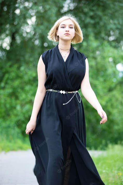 Premium Photo Seventeenyearold Blonde Girl In A Black Dress On A