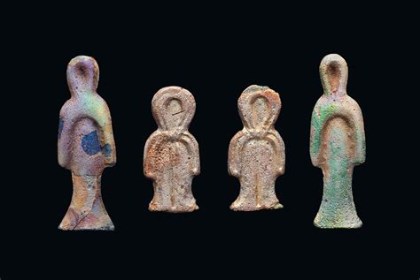 Four Egyptian Iridescent Glass Tyet Amulets