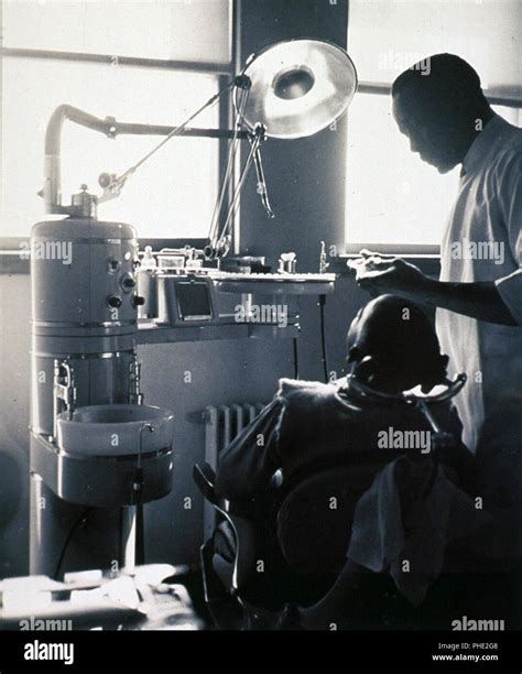 Interior View Of A Dental Office With An African American Patient