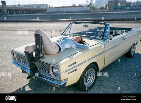 Woman Lying On Convertible Car Bonnet Los Angeles California Usa