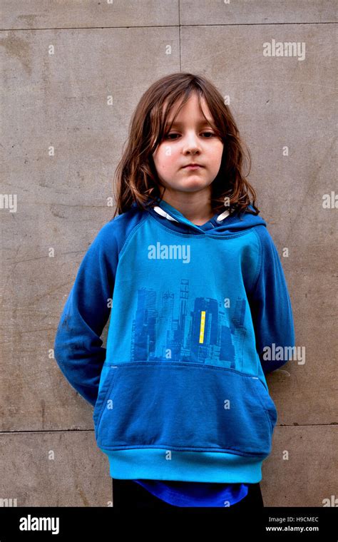 7 Year Old Boy Standing Quietly By Wall Stock Photo Alamy
