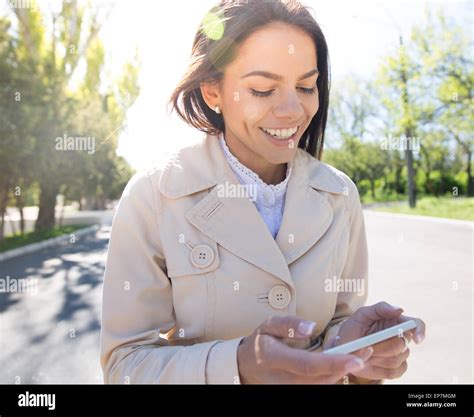 Beautiful Woman Walking Holding Smartphone High Resolution Stock