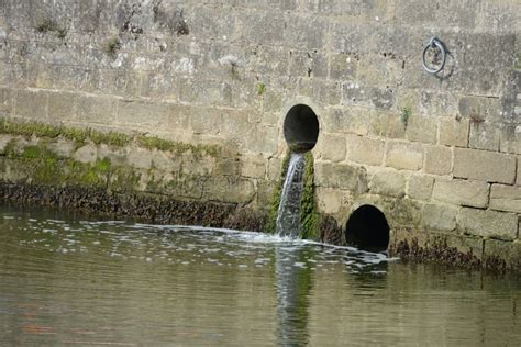 Water Coming Out Of A Sewer Flowing Into A Port In Brittany Stock Image