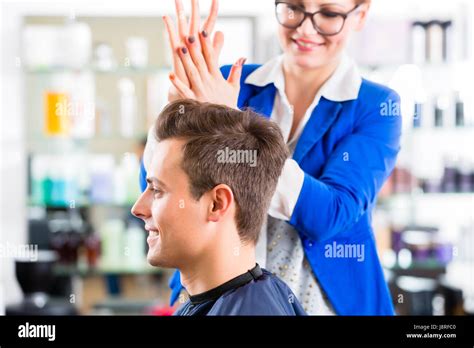 Hairdresser Cutting Man Hair In Barbershop Stock Photo Alamy