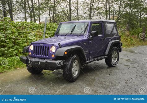 Purple Jeep Wrangler Parked In Rain On Roadside Turnout Editorial Image