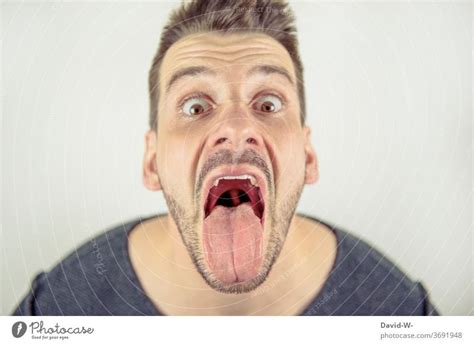 Man Looks Crazy Into The Camera With Open Mouth A Royalty Free Stock Photo From Photocase