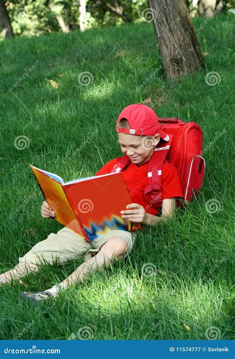 Boy Reads The Textbook Sitting On Stock Image Image Of Travel