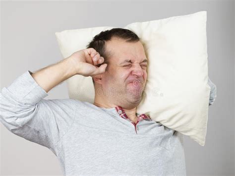 Sleepy Man With Pillow Closing His Ear Stock Image Image Of Oversleep