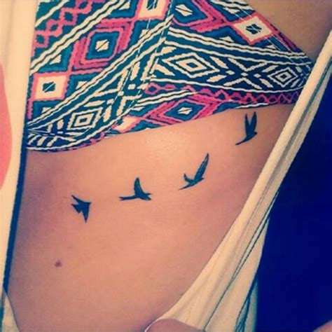 Side Tattoo Of Four Swallows On Julia Grillmeier