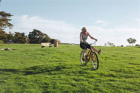 Vibrant Mature Woman Enjoying Herself On A Bicycle Del Colaborador De