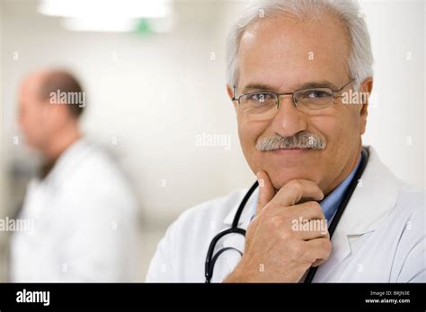 Doctor With Hand Under Chin Portrait Stock Photo Alamy