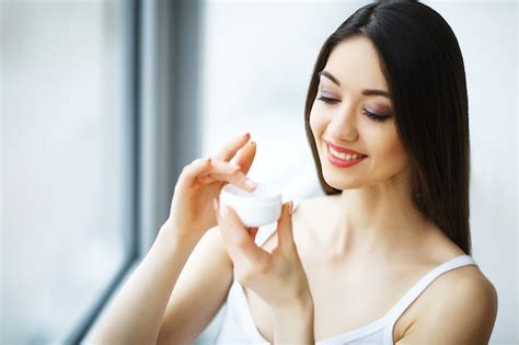 Premium Photo Beauty Face Care Woman Applying Cream On Skin
