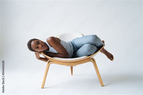 Calm Black Woman Lying On Chair In Studio Stock Photo Adobe Stock