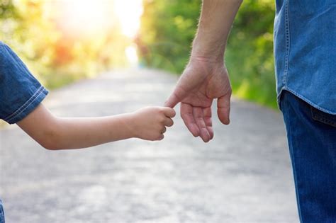 Premium Photo Parent Holds The Hand Of A Small Child