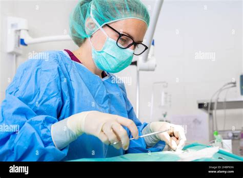 Close Up Portrait Of Female Surgeon Wearing Sterile Clothing Operating